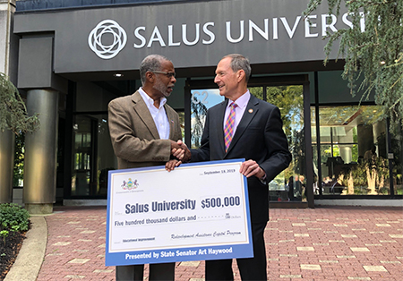 Senator Haywood Presents check to Salus University
